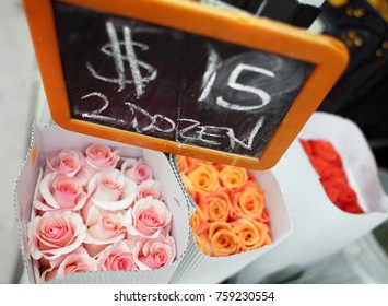 Dozen Roses Bouquet For Sale At Flower Market In Pink Orange Red Freshly Picked With Sign And Price Per Dozen