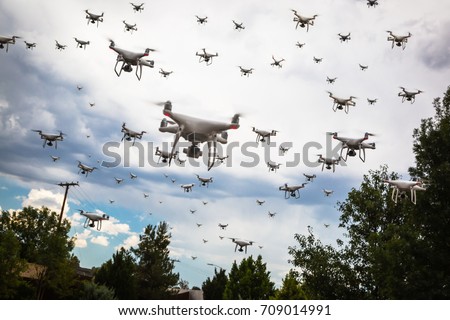 Dozens of Drones Swarm in the Cloudy Sky.