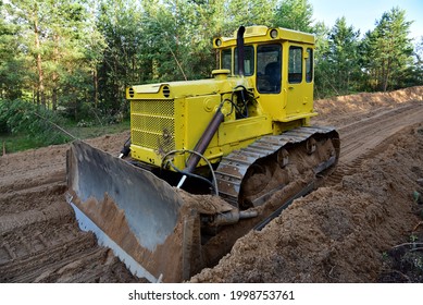 Dozer during clearing forest for construction new road. Bulldozer at forestry work Earth-moving equipment at road work, land clearing, grading, pool excavation, utility trenching