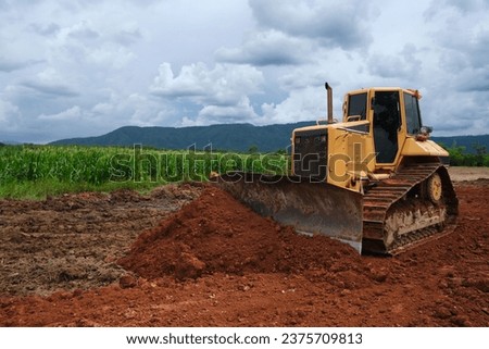 Dozer is pushing dirt. Bulldozer is working.