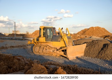 Dozer Working At Construction Site. Bulldozer For Land Clearing, Grading, Pool Excavation, Utility Trenching And Foundation Digging. Crawler Tractor And Earth-moving Equipment