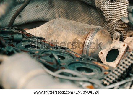 DPF . Diesel particulate filter under the hood near with a semi-disassembled engine. High quality photo