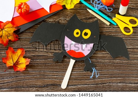 Dracola bat toy Halloween on a wooden table. Children's art project, craft for children. Craft for kids.