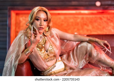 Dracula Vampire Girl On Haloween Day Sit On Sofa After Sucking Blood From Glass Bottle Then Leaking Finger Portrait
