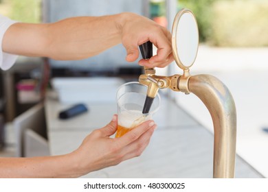 Draft Beer Pour In A Plastic Cup From The Crane