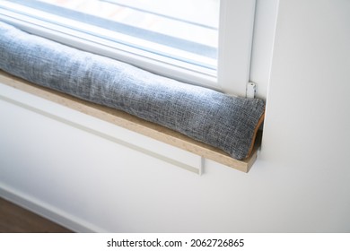 Draft Excluder Under Window Blocking Cold Air From Traveling Around