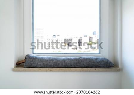 Draft Excluder Under Window Blocking Cold Air From Traveling Around