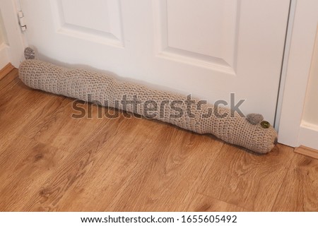 Draft excluder,hand made knitted sausage dog draft excluder in  the home to stop air passing under the door