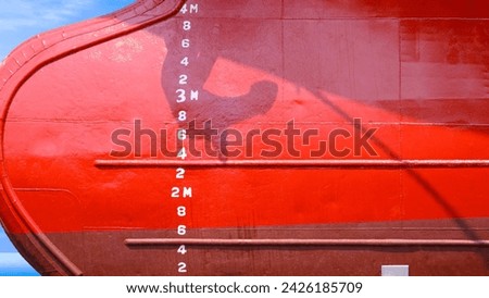 Draft mark numbers on red hull surface of oil tanker ship after Renovation work