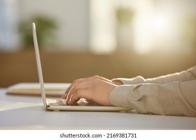 Drafting client emails. Cropped shot of an unrecognizable businessman sitting alone in the office and using his laptop.