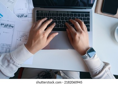 Draftsperson working on portable computer in workplace