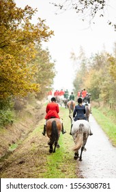 Drag Hunting Scene With Traditional Red Coated Fox Hunters In Autumn Colours.