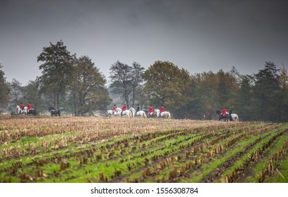 Drag Hunting Scene With Traditional Red Coated Fox Hunters In Autumn Colours.