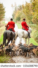 Drag Hunting Scene With Traditional Red Coated Fox Hunters In Autumn Colours.