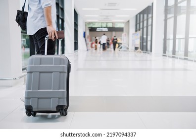 Drag luggage along the corridor in the airport. Business travel concept. - Shutterstock ID 2197094337