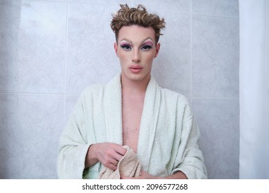 Drag Queen Person Wearing Bathrobe Looking At Camera In A Bathroom.