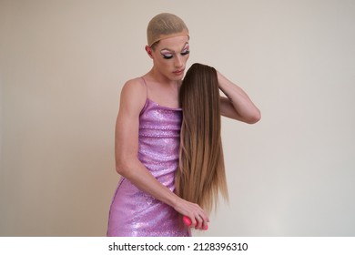 Drag Queen Person Wearing Sequined Pink Dress Combing A Wig. Getting Ready To Party.