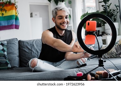 Drag queen streaming online makeup video tutorial with mobile phone indoors at home - Lgbt, gay, technology trendy concept - Focus in face - Powered by Shutterstock