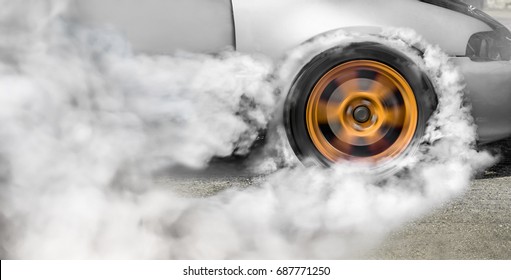 Drag racing car burns rubber off its tires in preparation for th