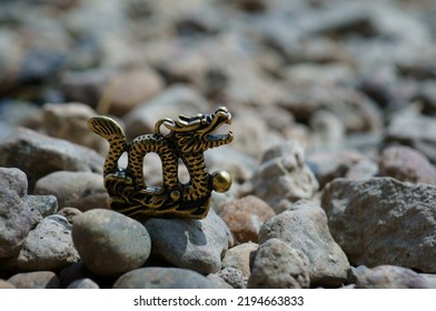 Dragon Figurine On The River Bank. Talismans And Amulets. A Symbol Of Supernatural Power.