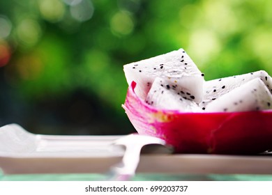 Dragon Fruit And Fruit Cake In A Dish, Bokeh Background With Green Color Of The Tree, Near The Pool, Summer Concept, Fresh And Relax.