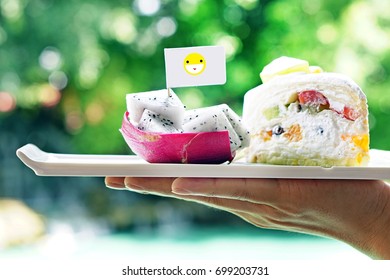 Dragon Fruit And Fruit Cake In A Dish, Put On The Hand,  Bokeh Background With Green Color Of The Tree, Near The Pool, Summer Concept, Fresh And Relax.