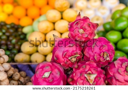 Dragon Fruit, also known as Pitaya, with other tropical fruits on display at a public market. Fresh and tasty organic fruits.