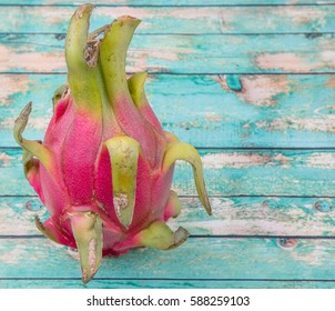 Dragon fruit over wooden background - Shutterstock ID 588259103