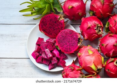 dragon fruit slice and cut half on white plate with pitahaya background , fresh red purple dragon fruit tropical in the asian thailand healthy fruit concept - top view
