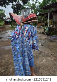 A Dragon Mask Toy That A Boy Plays In The Yard