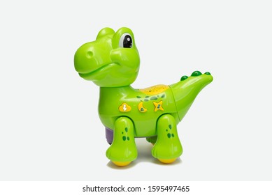 Dragon plushie doll isolated on white background with shadow reflection. Dragon plush stuffed puppet on white backdrop. Dino plushie toy. Green color stuffed dinosaur toy. Lizard toy sitting on white - Shutterstock ID 1595497465
