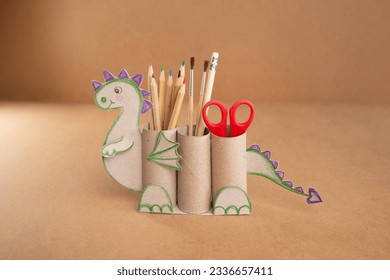 dragon shape a pencil holder made out of toilet paper and a pair of scissors, educational and craft activity - Powered by Shutterstock