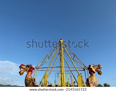 Dragon swing boats with blue sky background