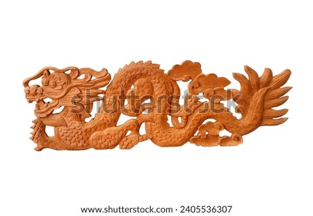 Dragon teak wood carving is handmade and isolated on a white background closeup.