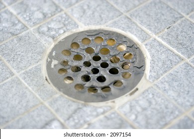 how to remove shower drain cover that is grouted in