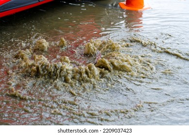 Drain After Severe Spring Storm On Flooded Street. Sewage Overflow On Pavement During Rain