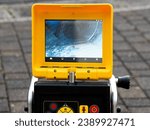 A drain cleaning company checks a blocked drain with a camera before flushing it out. Screen shows the cleaning process of the blocked pipe.