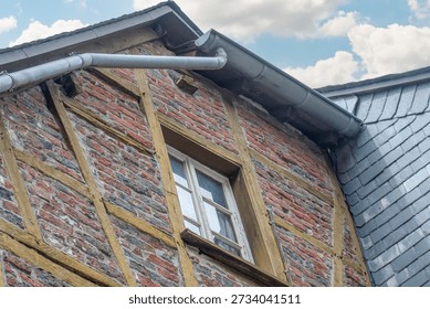 A drain with diagonal inserts and  this is a fragment of a European antique house from a bygone era