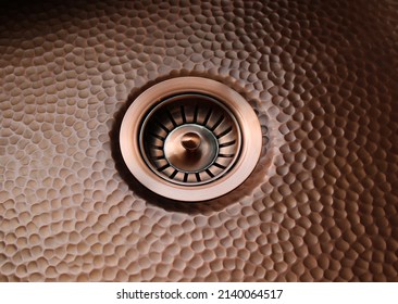 A Drain In A Hammered Copper Sink