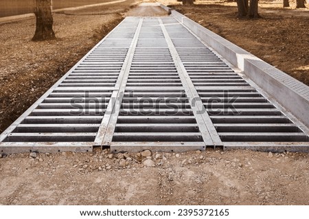 Drainage Concrete Lattice Grid on Park Path. Construction of Park Walkway with Huge Drainage Footpath for Storm Water close up.
