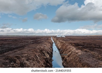 Drainage ditch in the peat extraction site. Drainage and destruction of peat bogs.