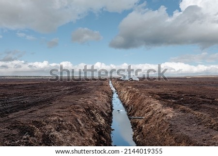 Drainage ditch in the peat extraction site. Drainage and destruction of peat bogs.