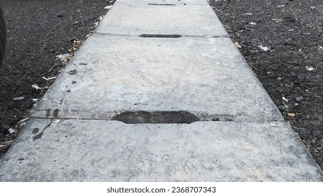 Drainage made from a cement mixture is installed in parking area - Shutterstock ID 2368707343