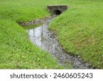 Drainage pipe connecting the ditch under the bridge in the Park