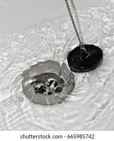 Draining Water With The Drain Rubber Plug On Shower Bath.
