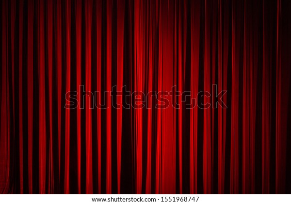 Drama theatre concept.
Dark red colour stage curtain before show. Deep shadows.
Text-space. Indoor shot