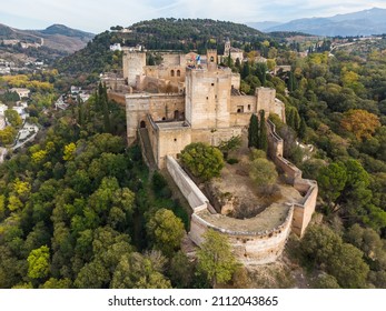 Dramatic aerial view of the Alhambra palace and fortress in Granada with the Torre de la Vela tower in Andalusia in southern Spain.