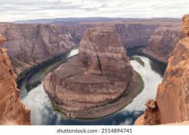 A dramatic aerial view of Horseshoe Bend, a stunning rock formation carved by the Colorado River. This natural wonder showcases the unique horseshoe-shaped bend in the canyon. - Powered by Shutterstock