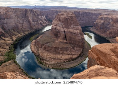 A dramatic aerial view of Horseshoe Bend, a stunning rock formation carved by the Colorado River. This natural wonder showcases the unique horseshoe-shaped bend in the canyon. - Powered by Shutterstock