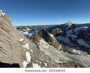 Dramatic Aerial View of Snow-Capped Mountains and Glaciers in the Alps - Powered by Shutterstock